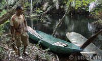 Pygmy fisherman returning from fishing on a pirogue